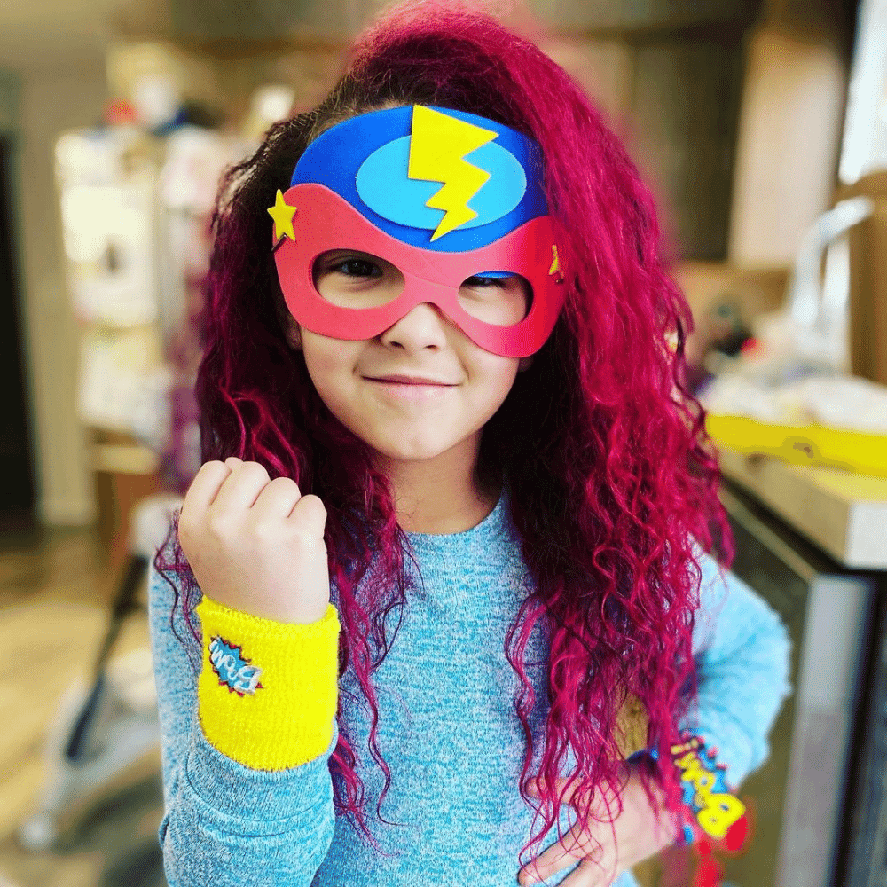 Girl with superhero costume craft
