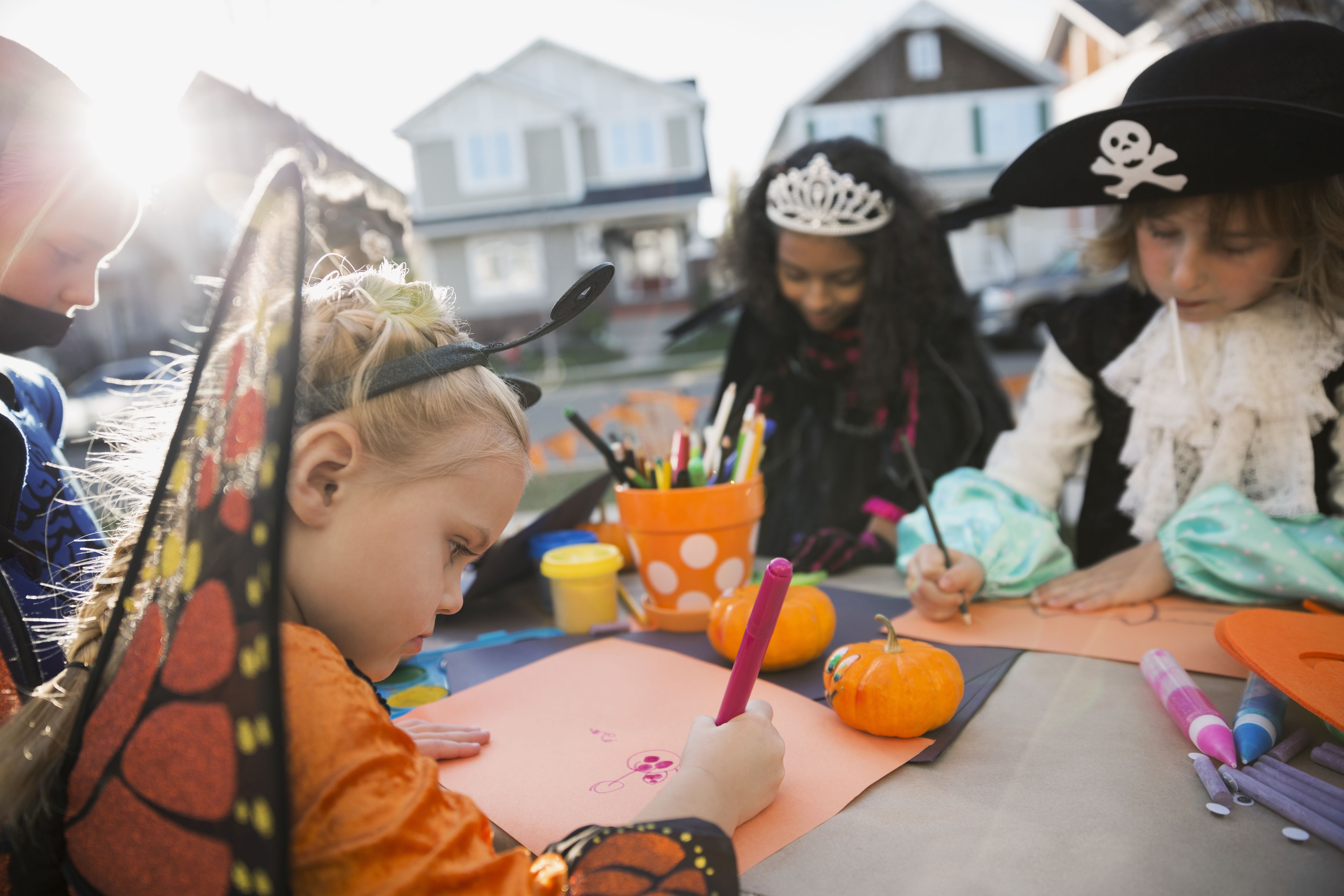 Kids in Halloween costumes doing crafts