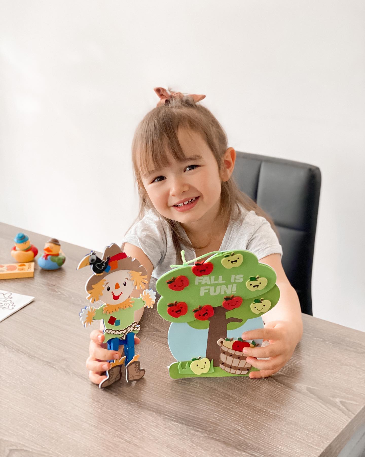 Child showing fall craft creation