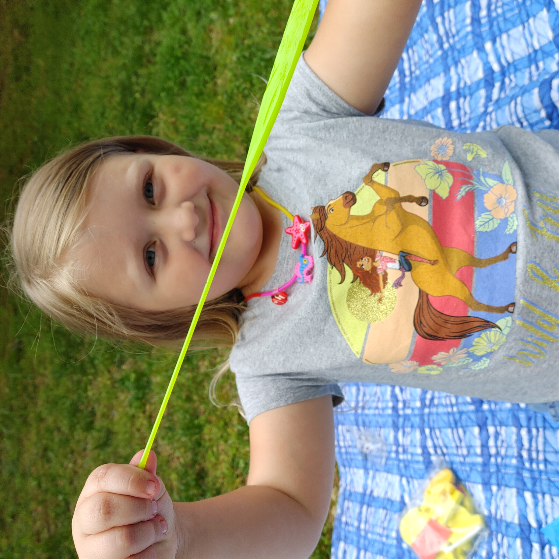 Child with summer activity box contents