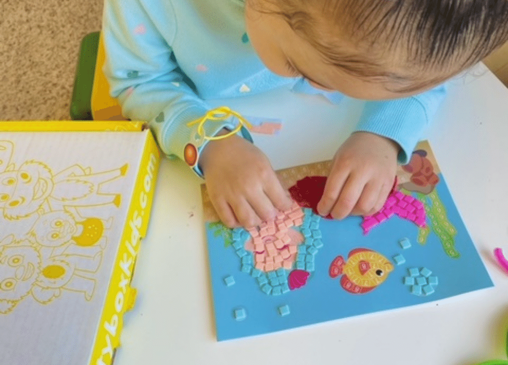 Inside a summer craft box with ocean-themed activities and supplies