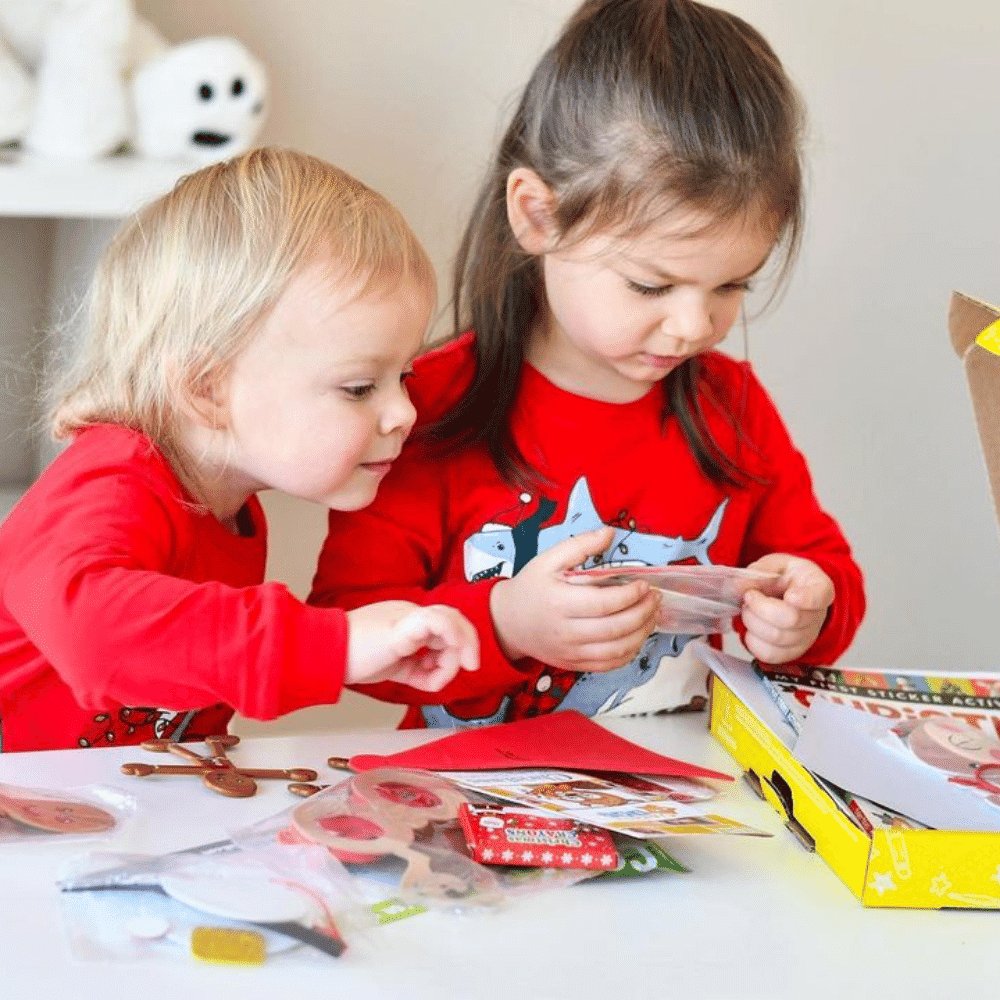 Inside a winter craft box with Christmas-themed activities and supplies